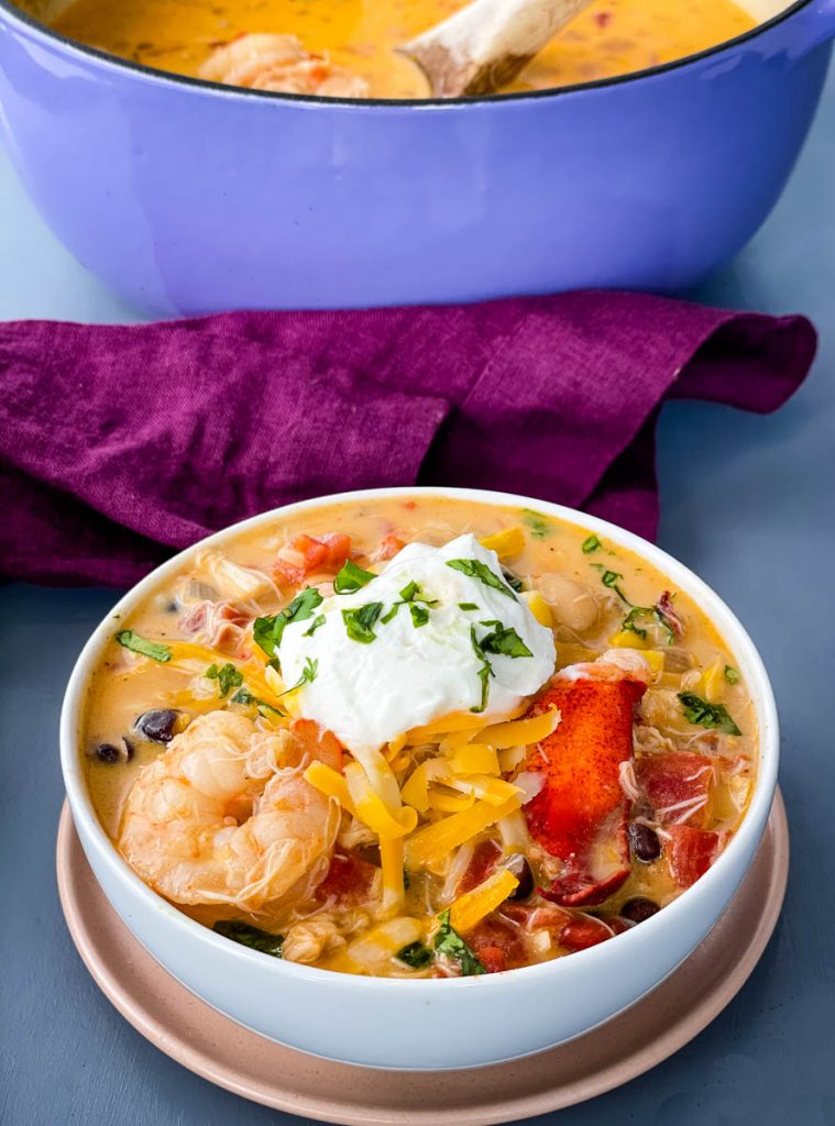 creamy seafood chili with shrimp and lobster in a white bowl