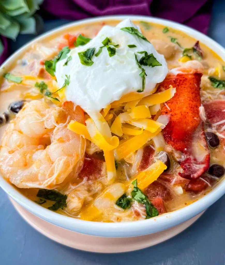 creamy seafood chili with shrimp and lobster in a white bowl