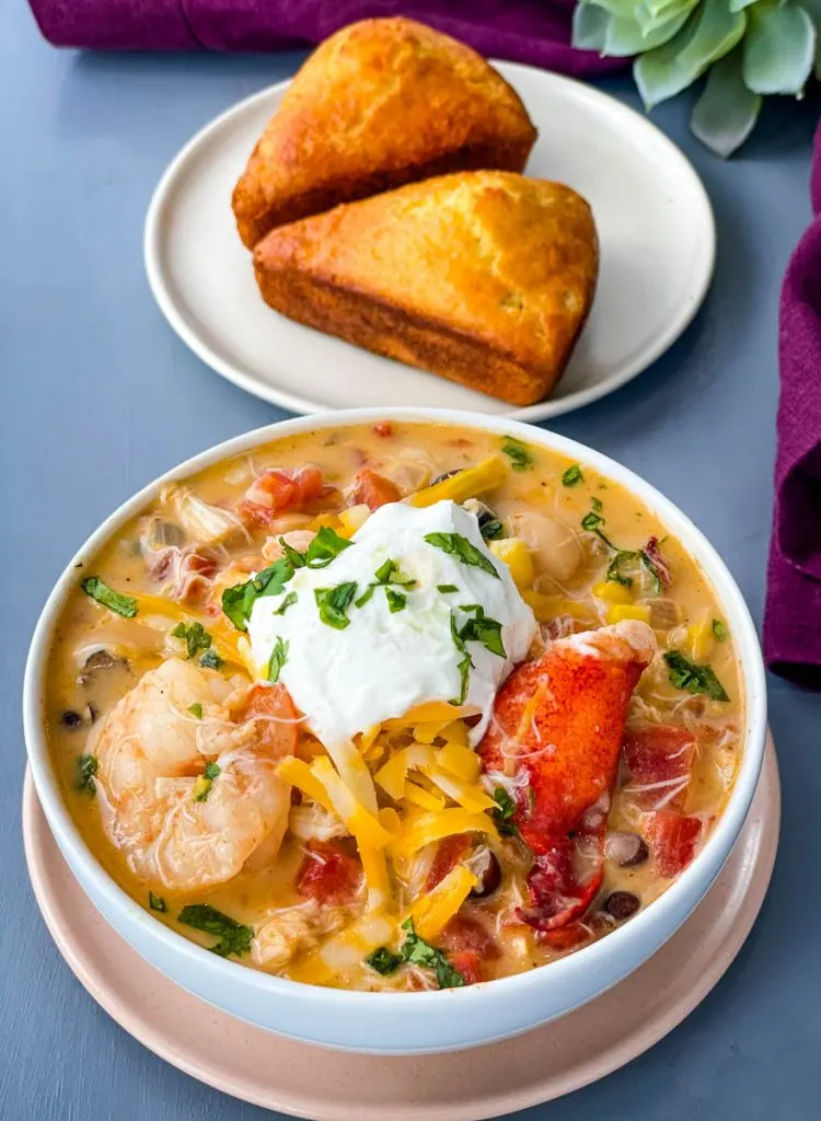 creamy seafood chili with shrimp and lobster in a white bowl