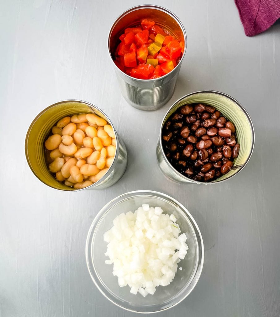 canned Great Northern beans, canned black beans, Rotel, and chopped onions in separate containers