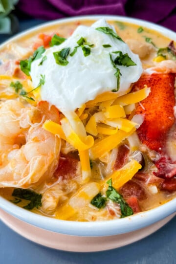 creamy seafood chili with shrimp and lobster in a white bowl