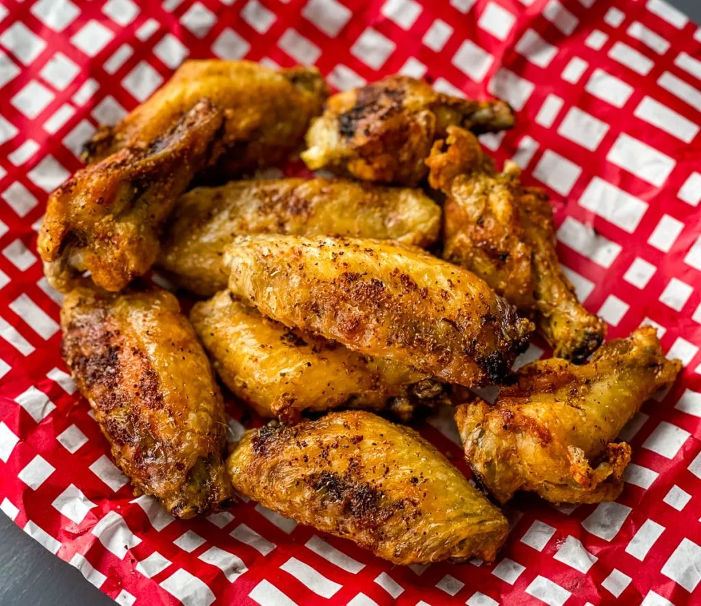 air fryer chicken wings in a red and white basket