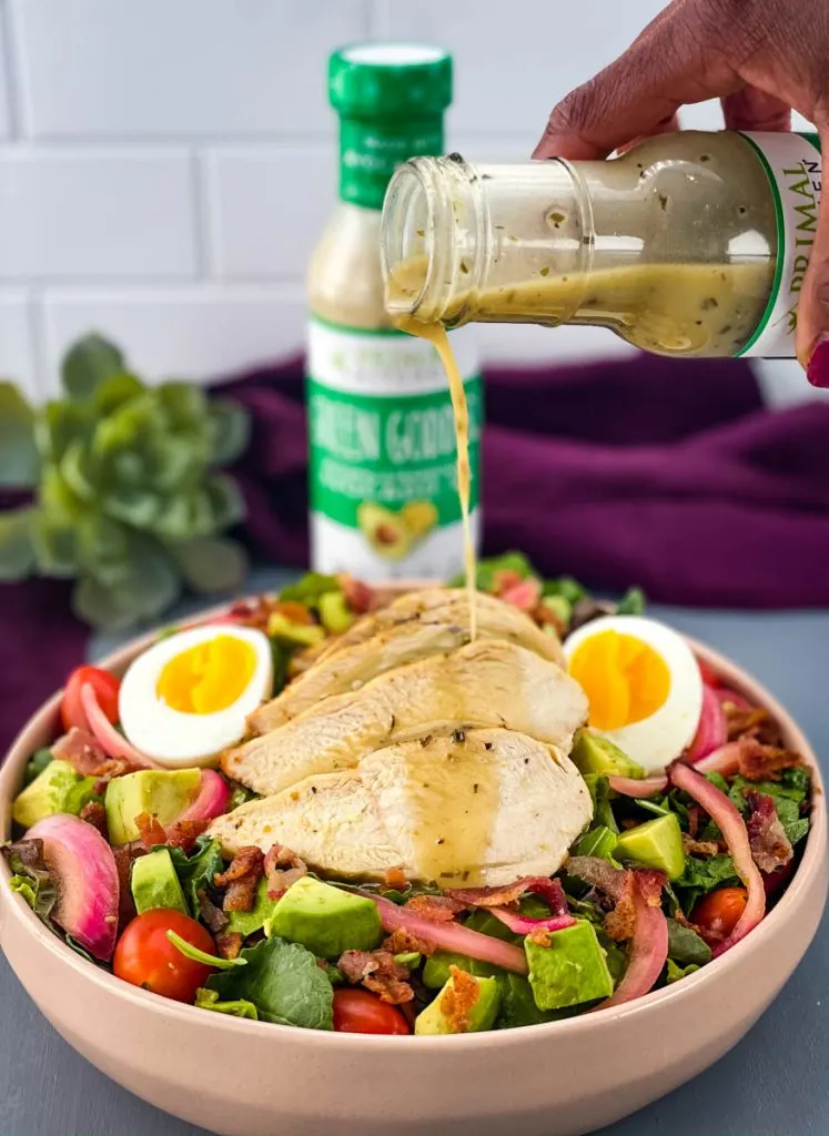 salad dressing drizzled over green goddess cobb salad