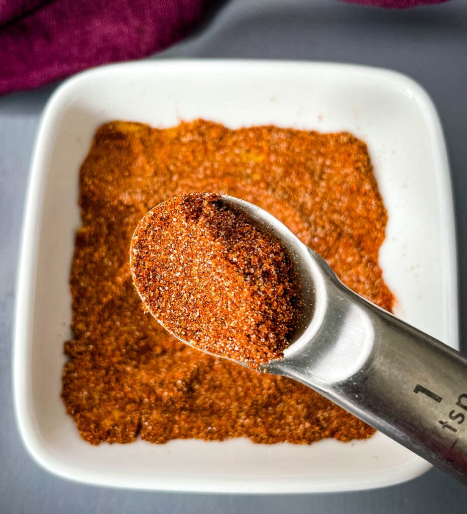 homemade taco seasoning in a white bowl with a spoon