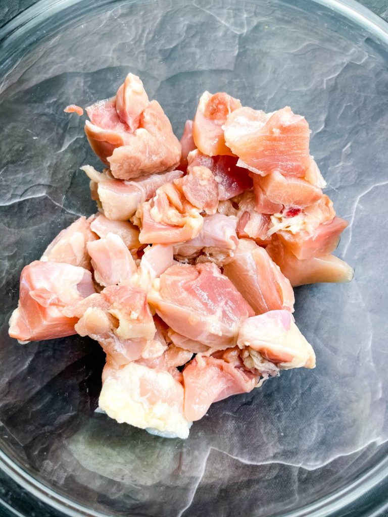 raw chicken thighs in a glass bowl