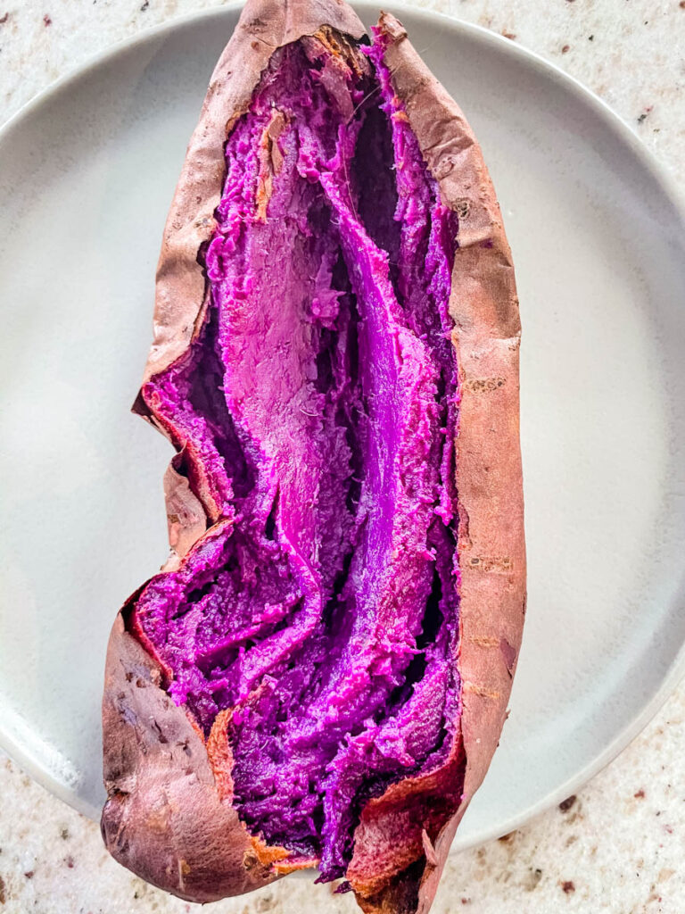 Stokes purple sweet potato fully cooked and sliced open on a plate
