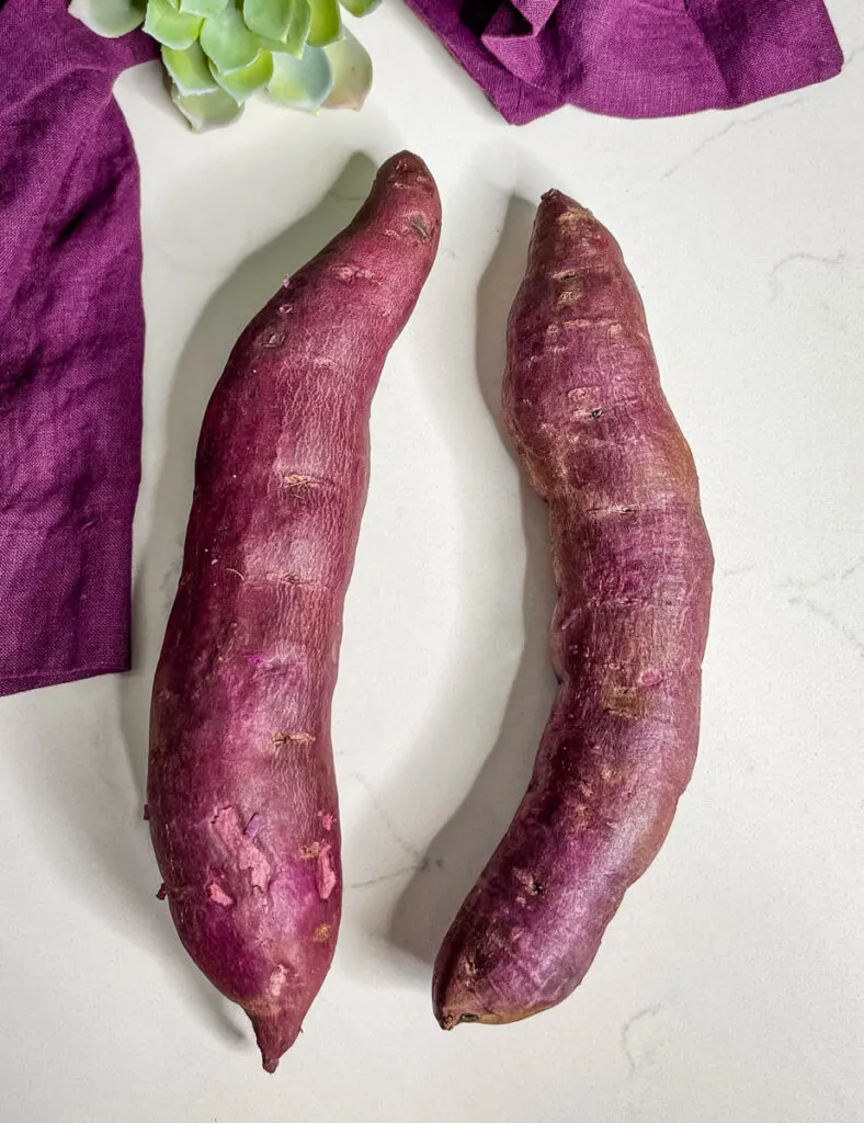 raw Stokes purple sweet potato on a flat surface