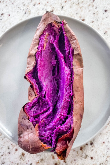 Stokes purple sweet potato fully cooked and sliced open on a plate