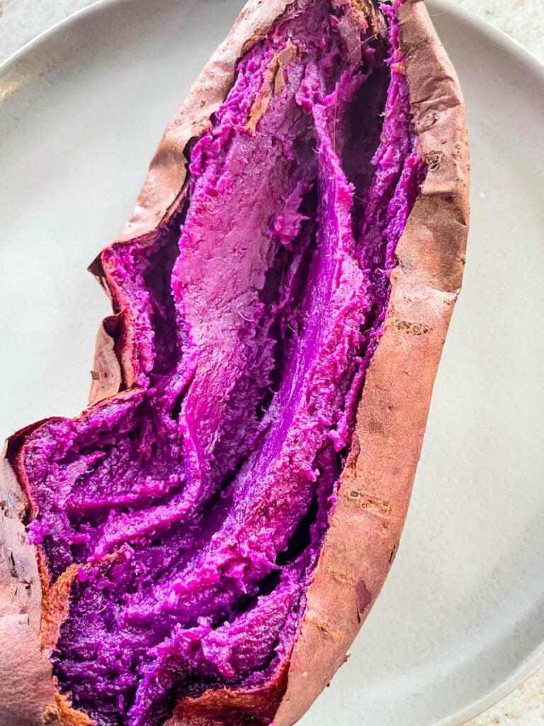 Stokes purple sweet potato fully cooked and sliced open on a plate