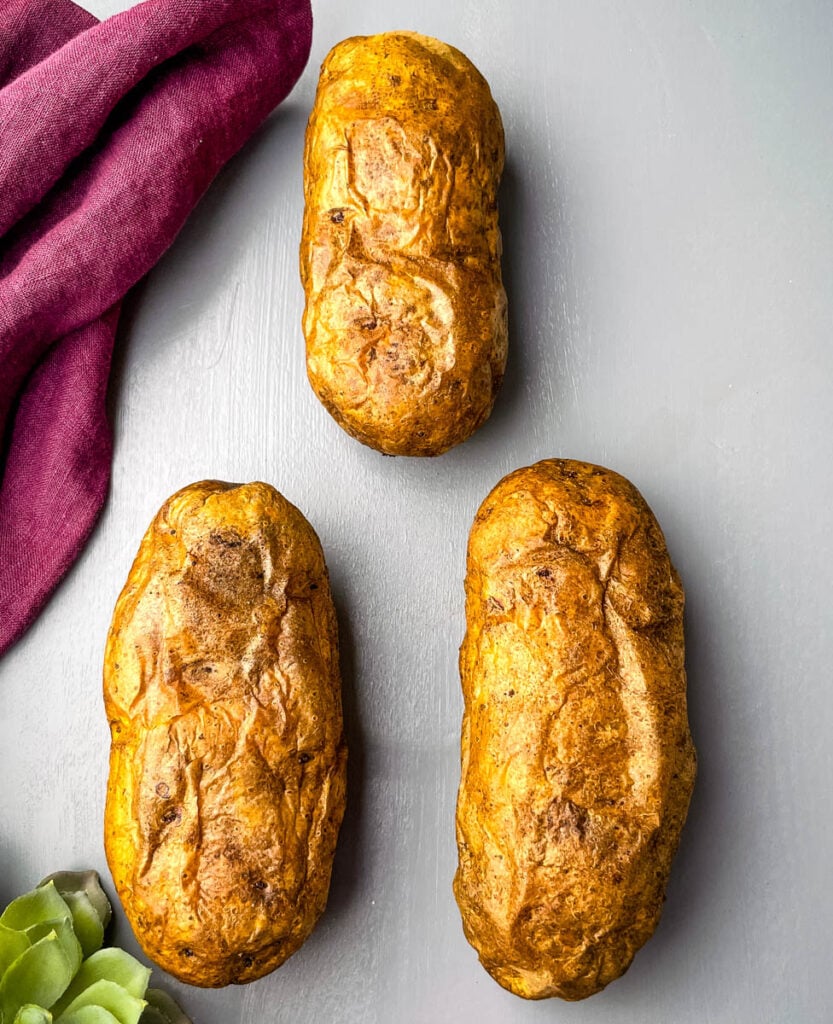 baked russet potatoes on a flat surface