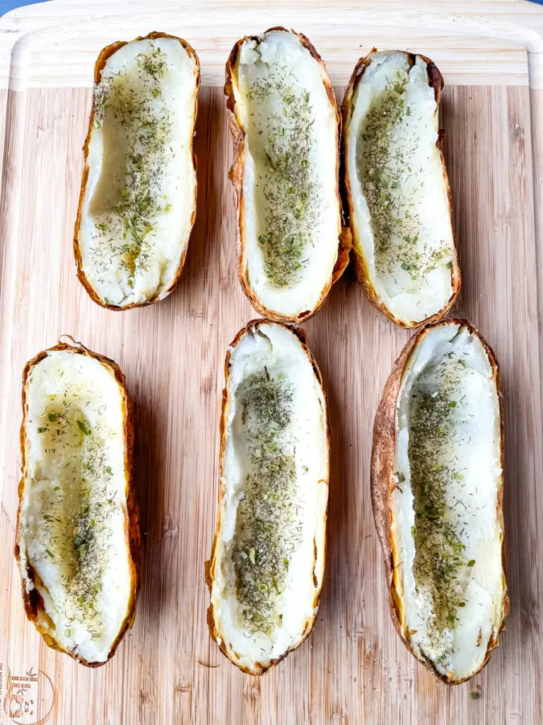 baked russet potatoes sliced in half with ranch seasoning