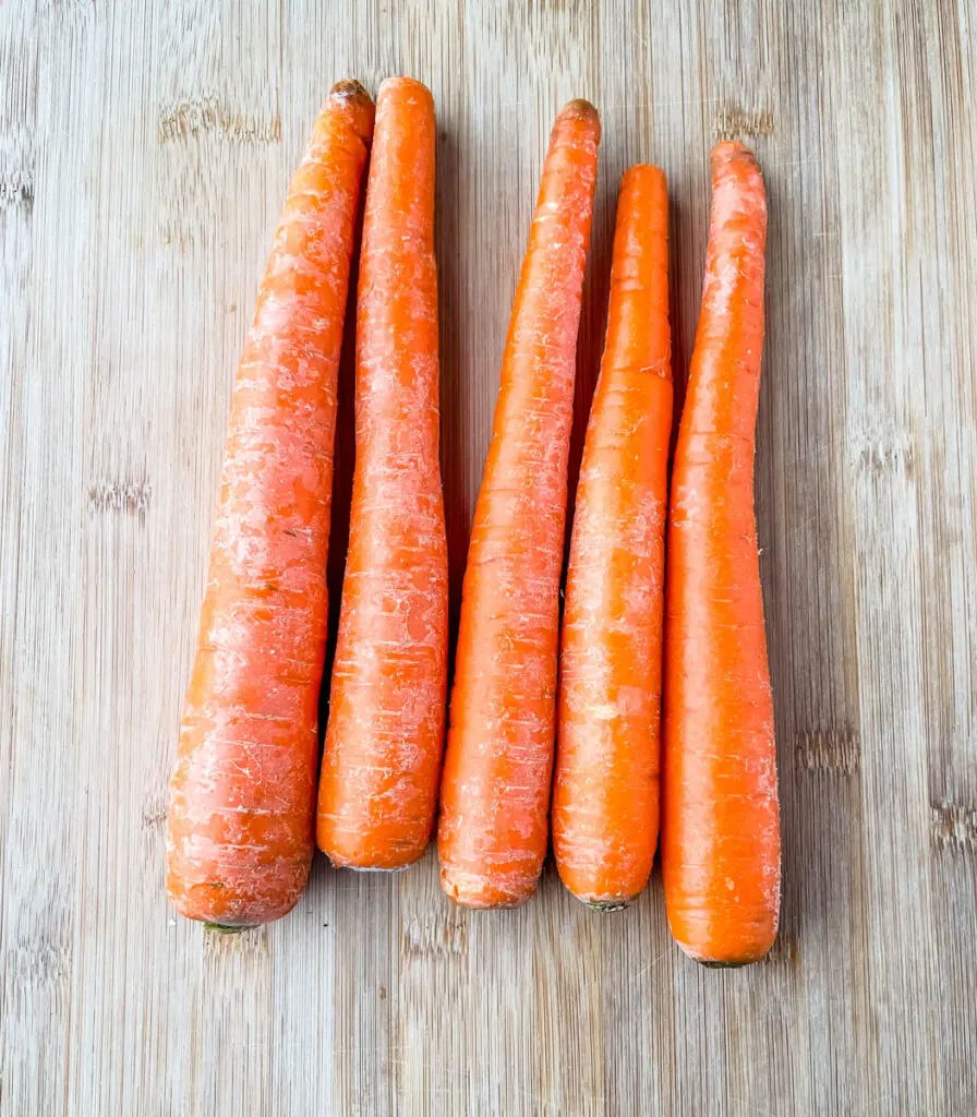 raw carrots on a cutting board