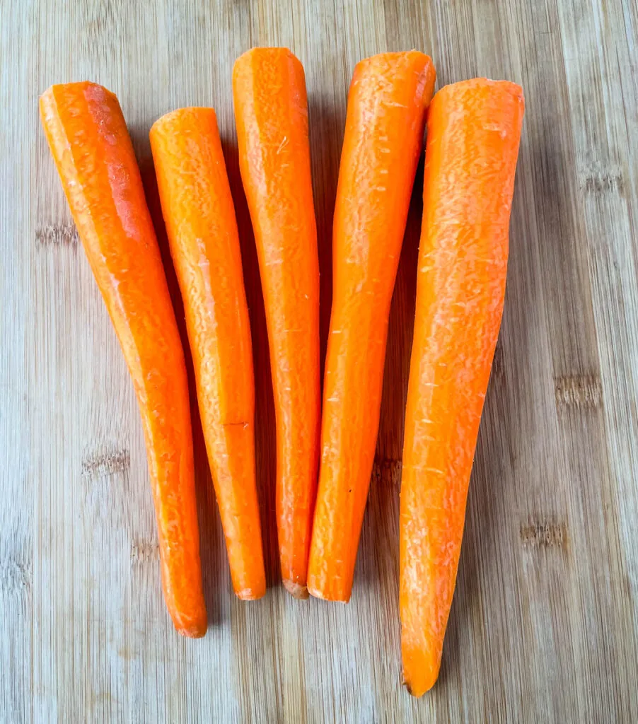 raw carrots on a cutting board