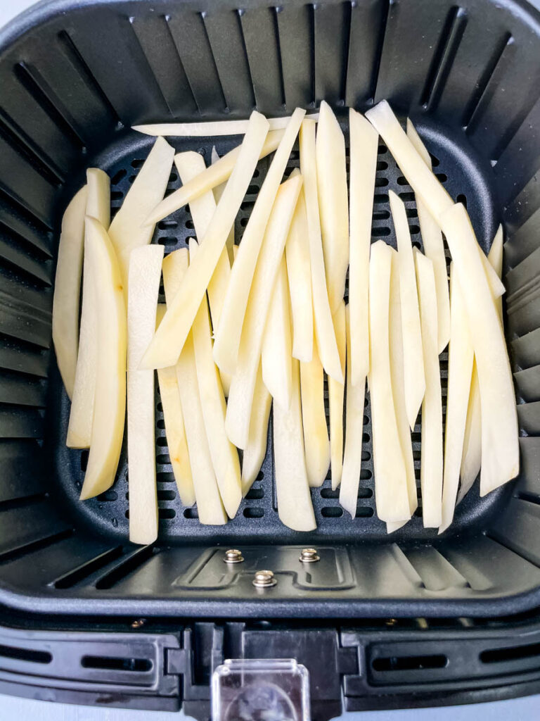 sliced potatoes in an air fryer