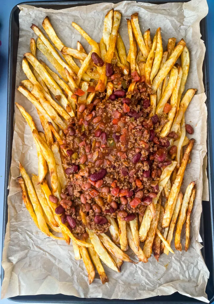 cooked French fries on a sheet pan with chili