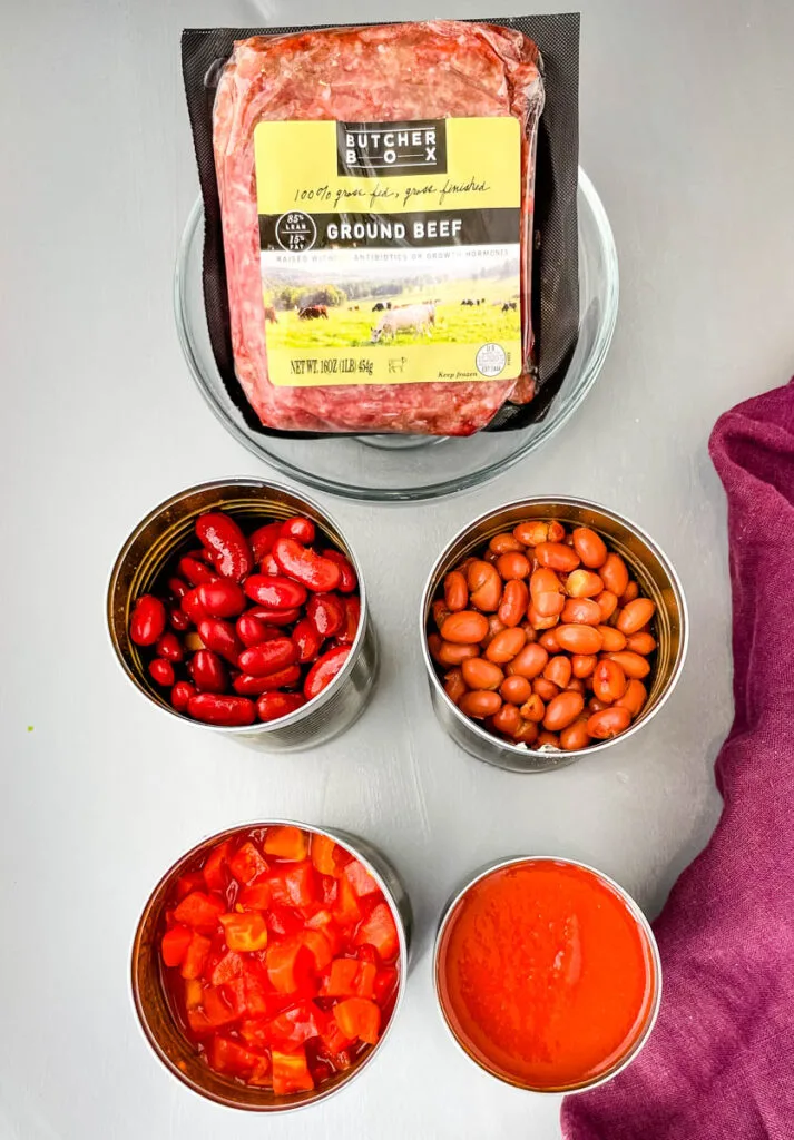 ground beef, beans, diced tomatoes, and tomato sauce in separate containers