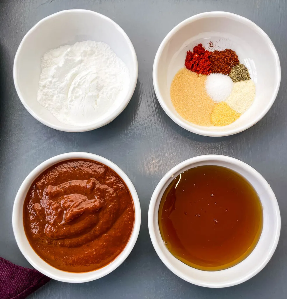 baking powder, BBQ rub, maple syrup, and BBQ sauce in separate white bowls