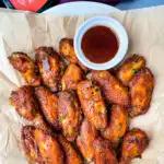 keto low carb chicken wings on a plate with maple syrup and BBQ sauce