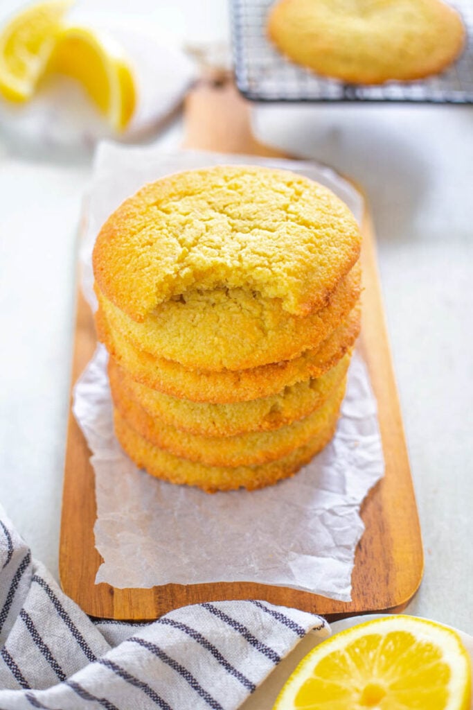 a stack of keto low carb lemon cookies, one on type with a bite taken out