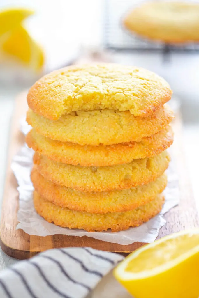 a stack of keto low carb lemon cookies, one on type with a bite taken out