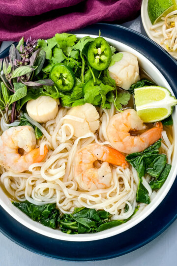 seafood shrimp pho in a white bowl