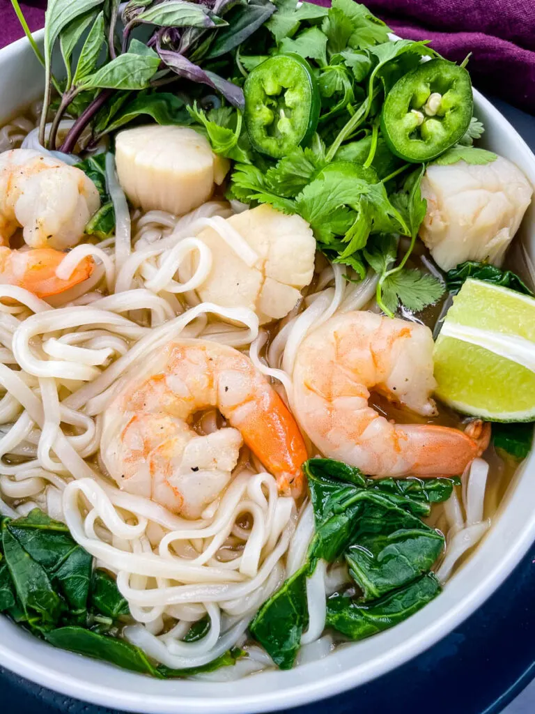 seafood shrimp pho in a white bowl