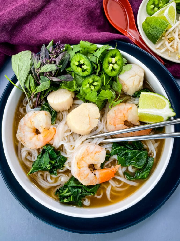 seafood shrimp pho in a white bowl