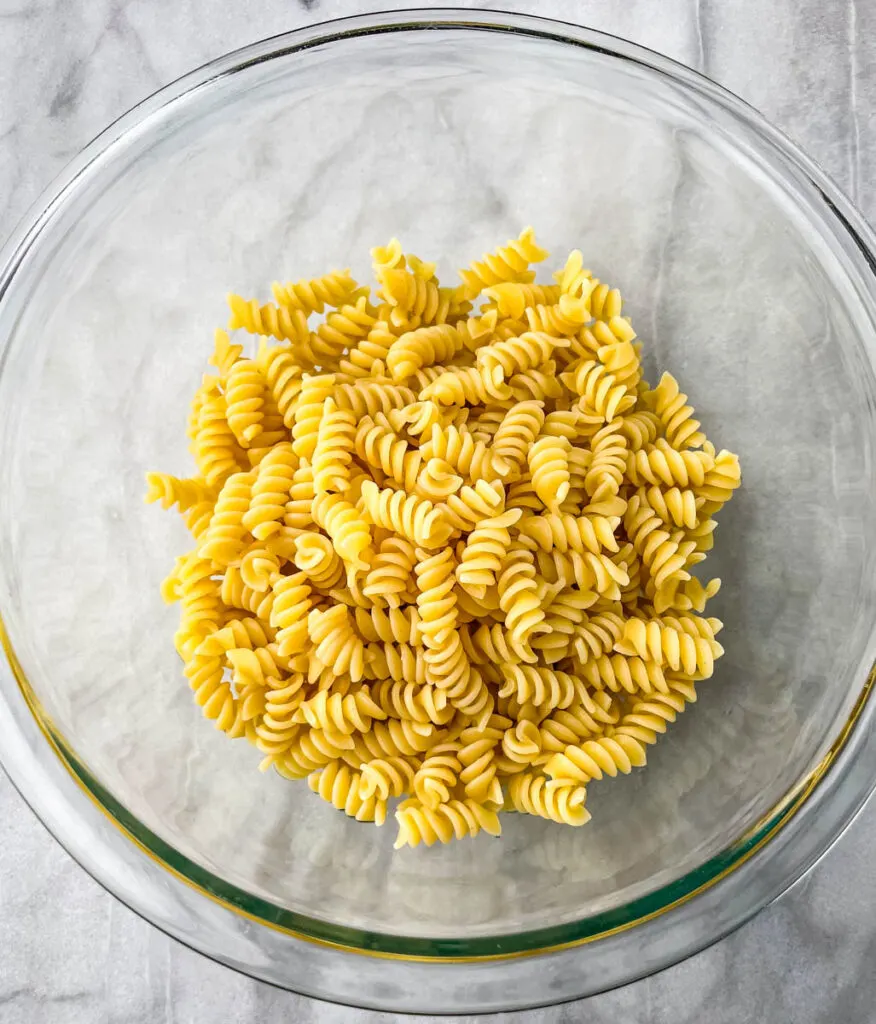 cooked rotini pasta in a glass bowl