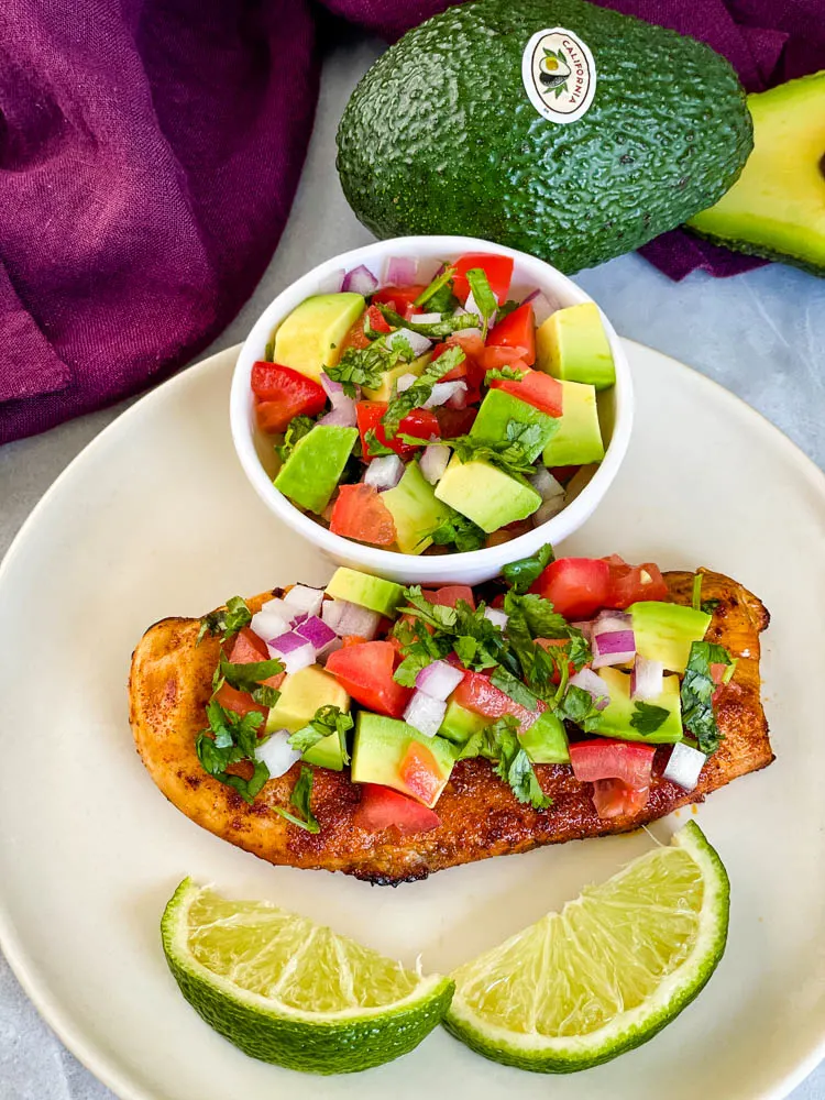 cooked chicken and avocado salsa on a plate