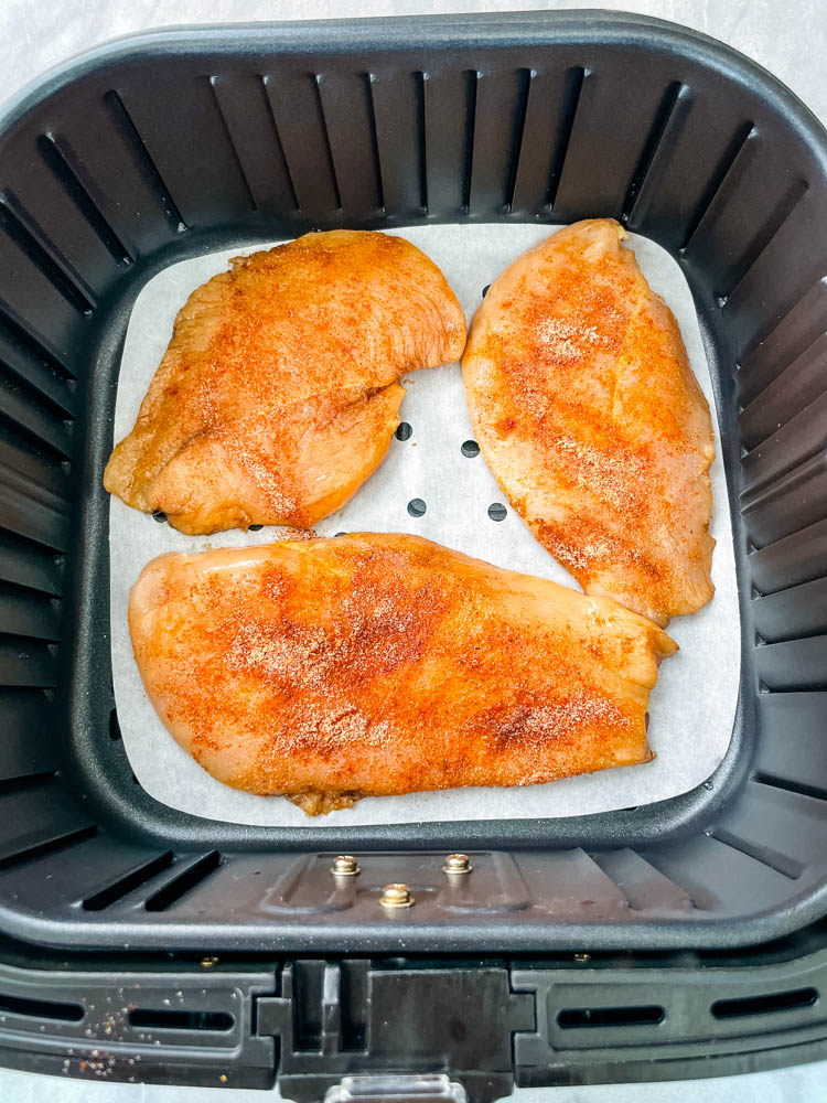 raw chicken breasts in an air fryer