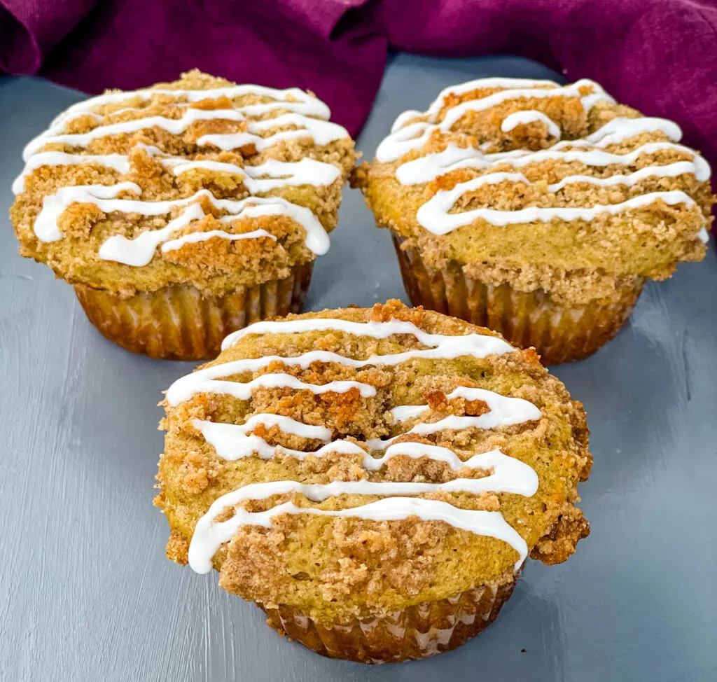 coffee cake muffins with icing on a flat surface