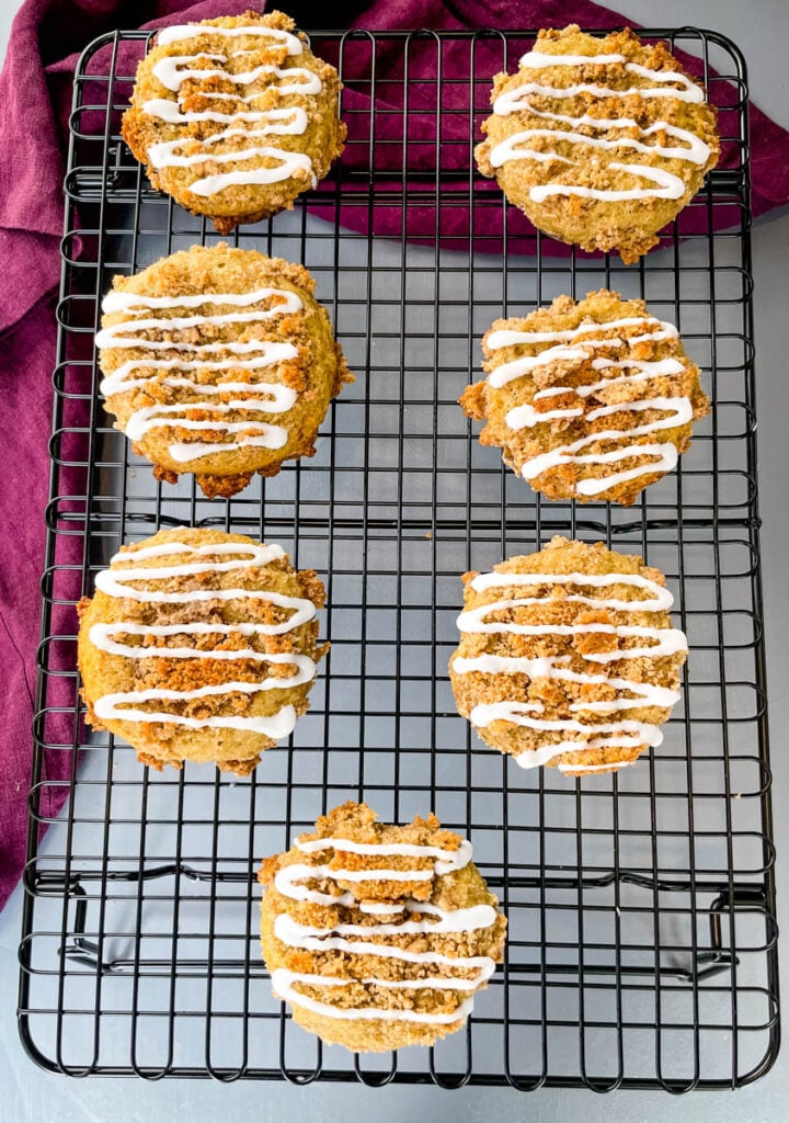coffee cake muffins with icing on a cooling rack