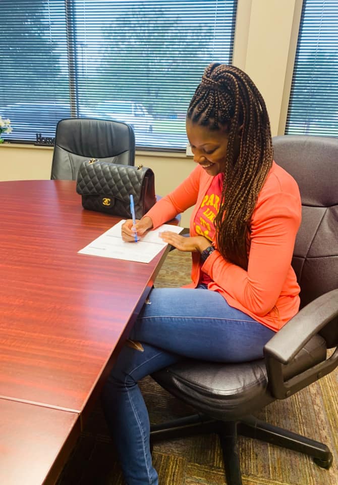 person sitting at a table with a document