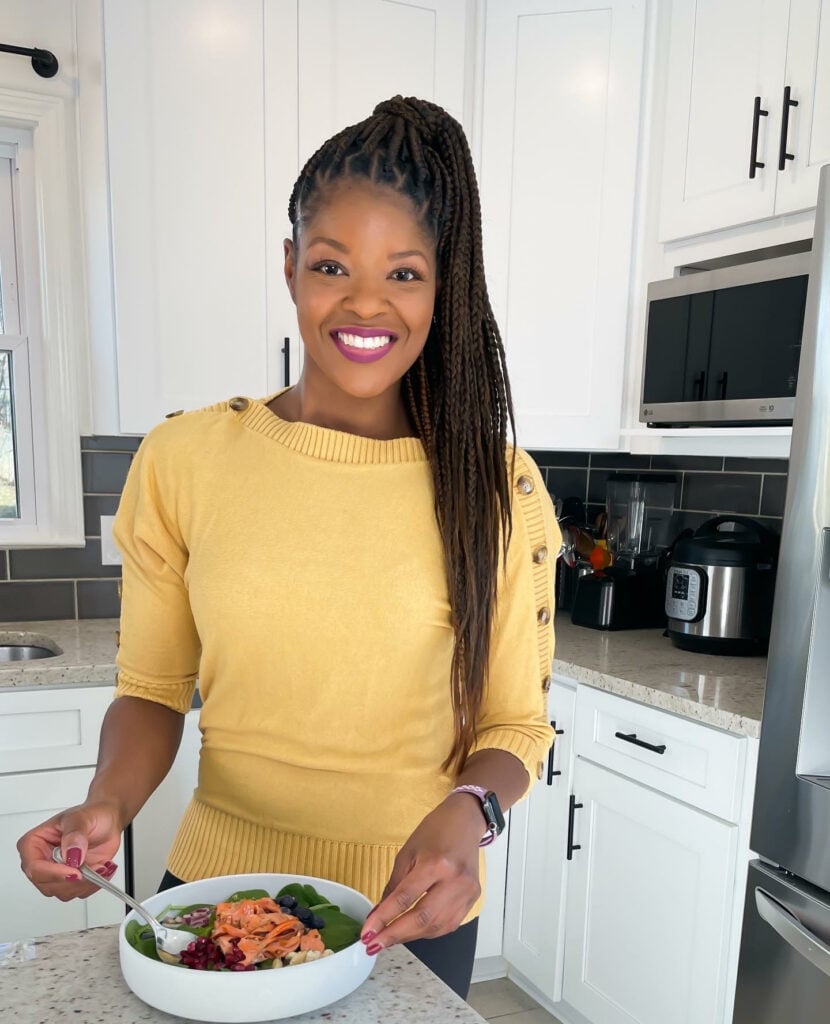 person standing in kitchen with a bowl of food