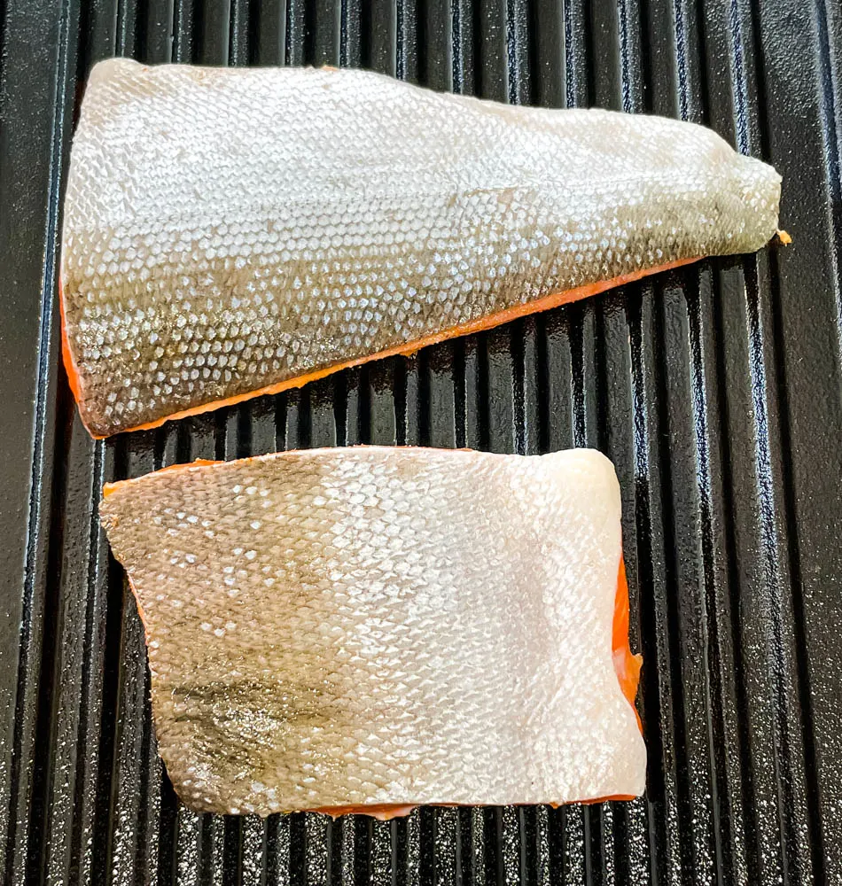 raw wild caught salmon cooked in a grill pan