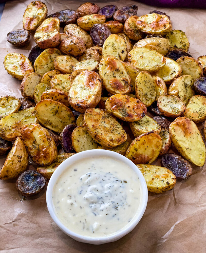 roasted ranch potatoes on a plate with ranch dressing