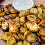 roasted ranch potatoes on a plate with ranch dressing