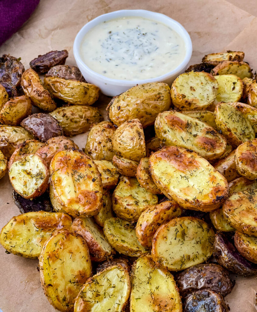 roasted ranch potatoes on a plate with ranch dressing