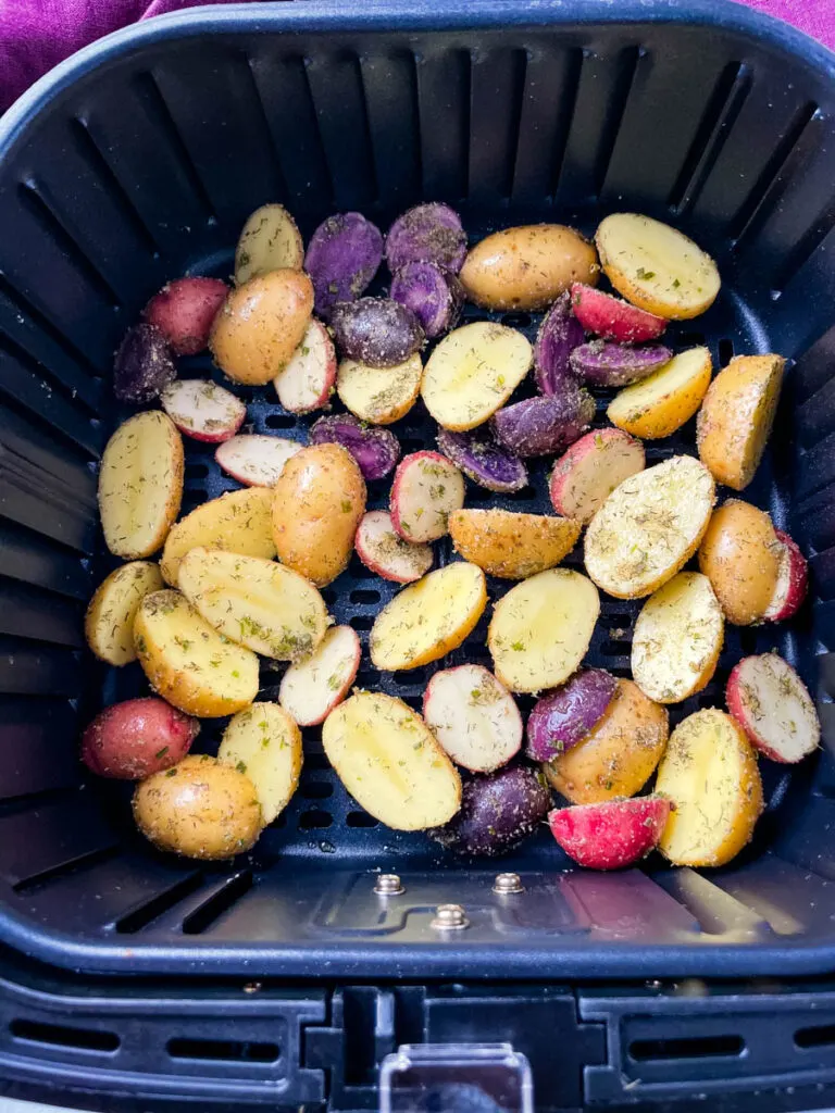 raw sliced potatoes in an air fryer