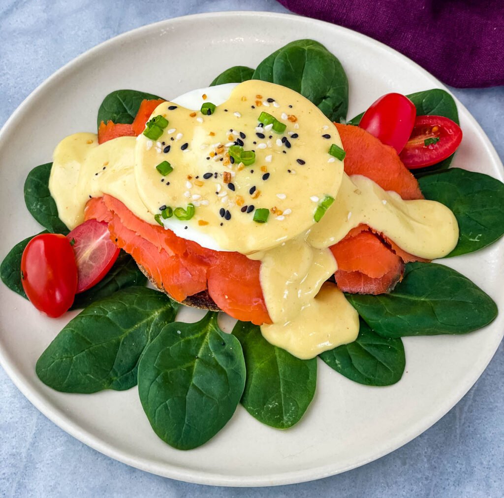 smoked salmon eggs Benedict on a bed of spinach