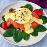 smoked salmon eggs Benedict on a bed of spinach