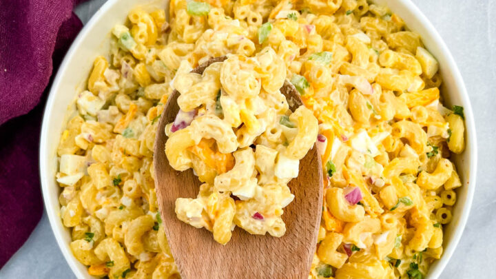 southern macaroni salad in a wooden spoon over a bowl