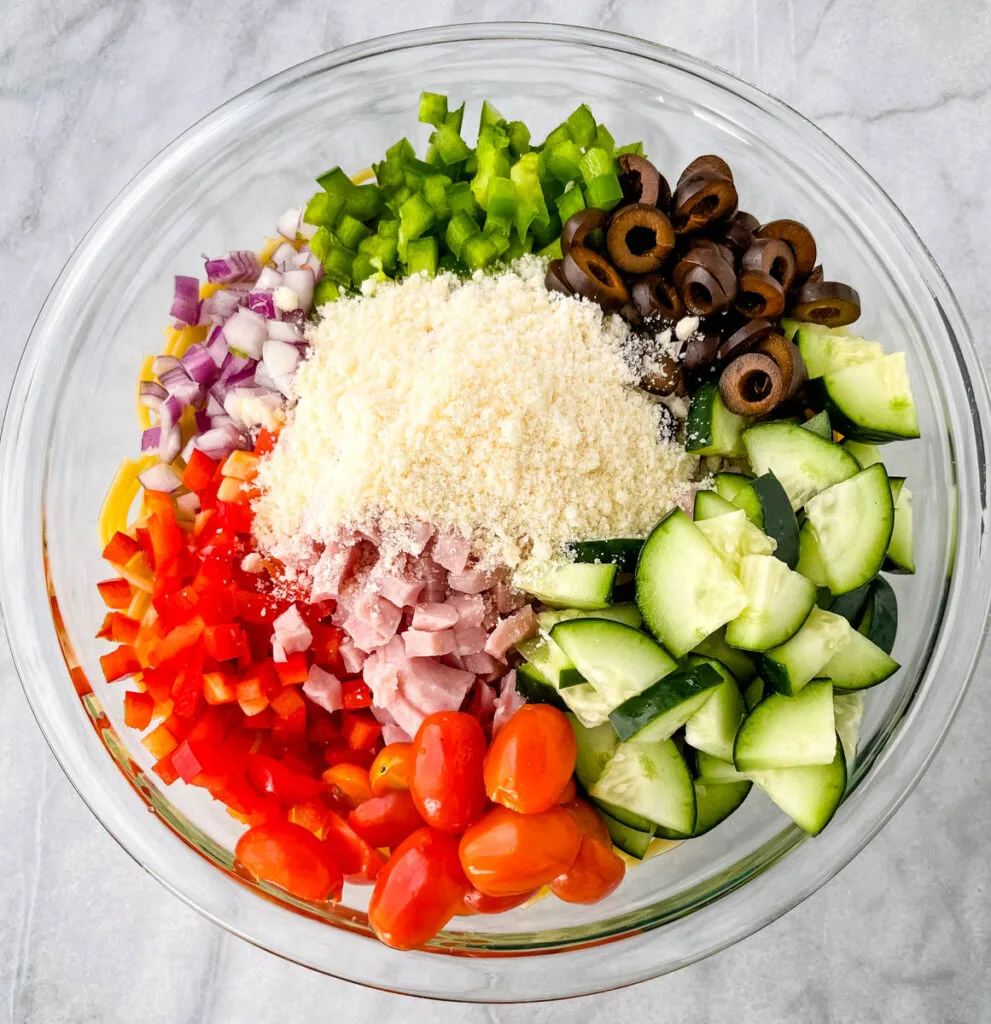 spaghetti salad and vegetables in a glass bowl