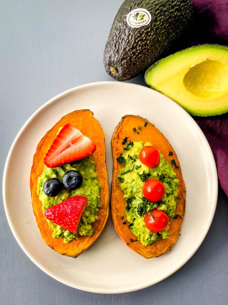 sweet potato avocado toast on a plate with fresh fruit