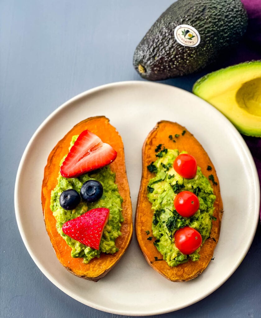 sweet potato avocado toast on a plate with fresh fruit