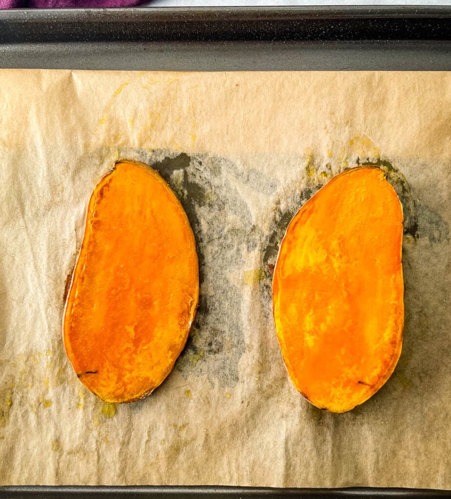 sliced baked sweet potatoes on a sheet pan