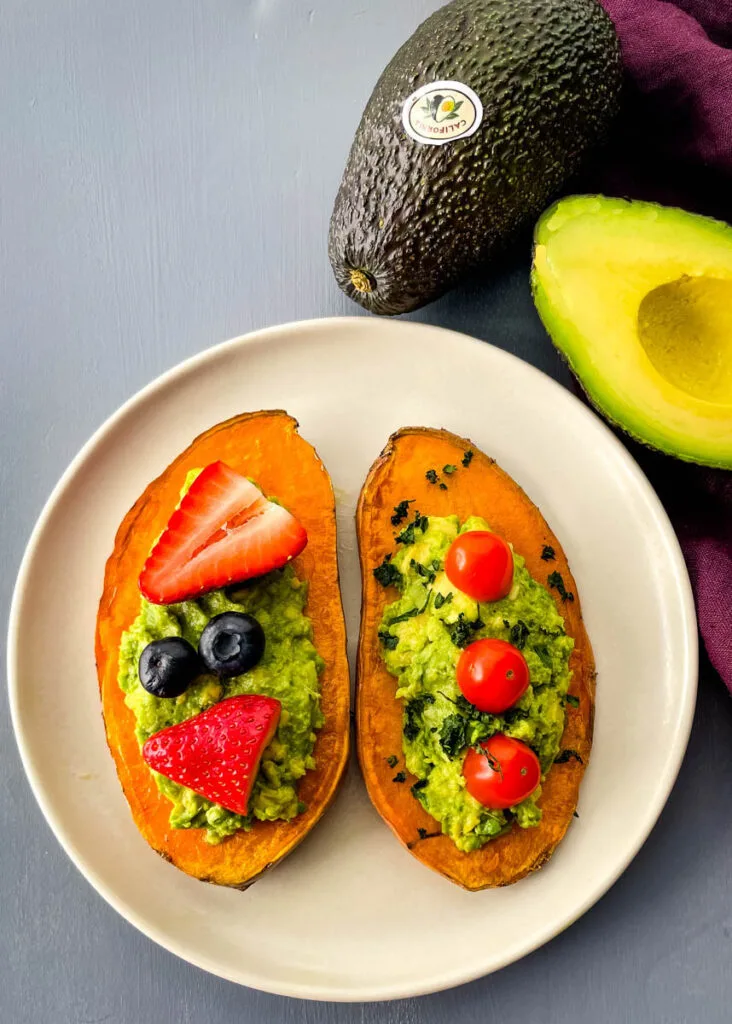 sweet potato avocado toast on a plate with fresh fruit
