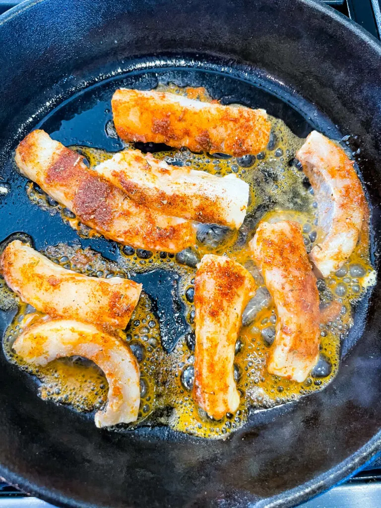 blacked cod fish in a cast iron skillet