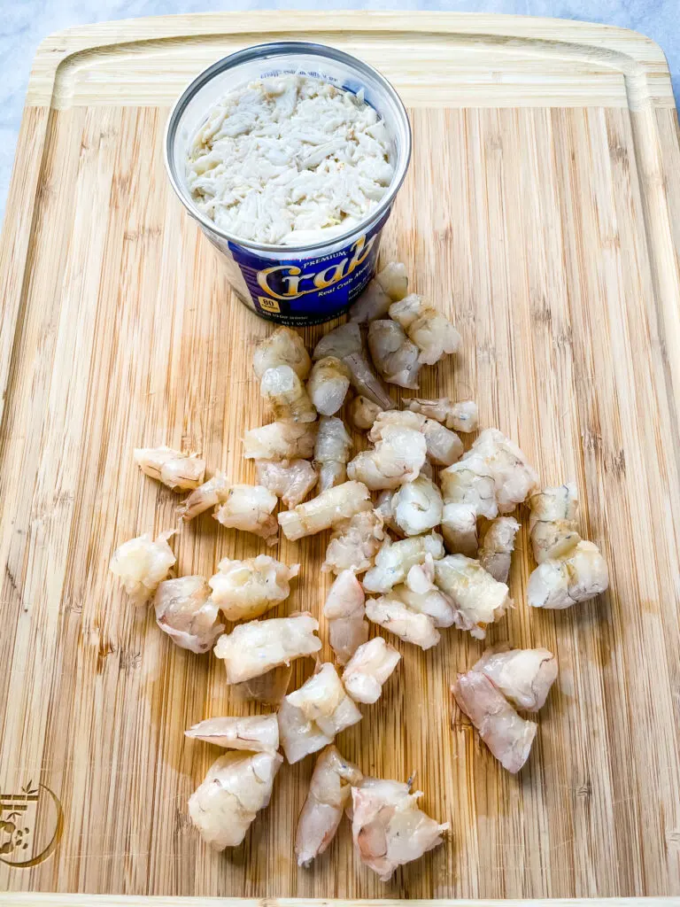 raw shrimp and jumbo crab on a cutting board