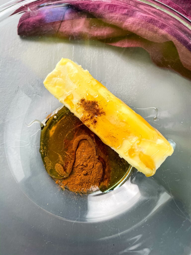 butter, cinnamon, and maple syrup in a glass bowl